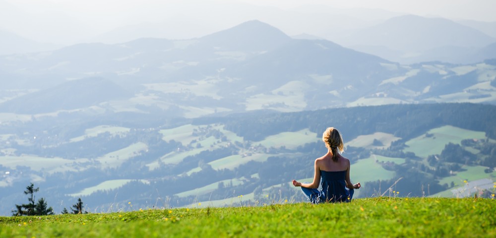 Young woman meditating outdoors