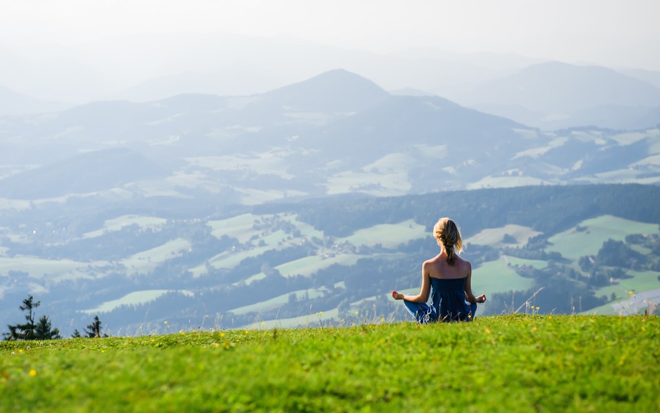 Young woman meditating outdoors