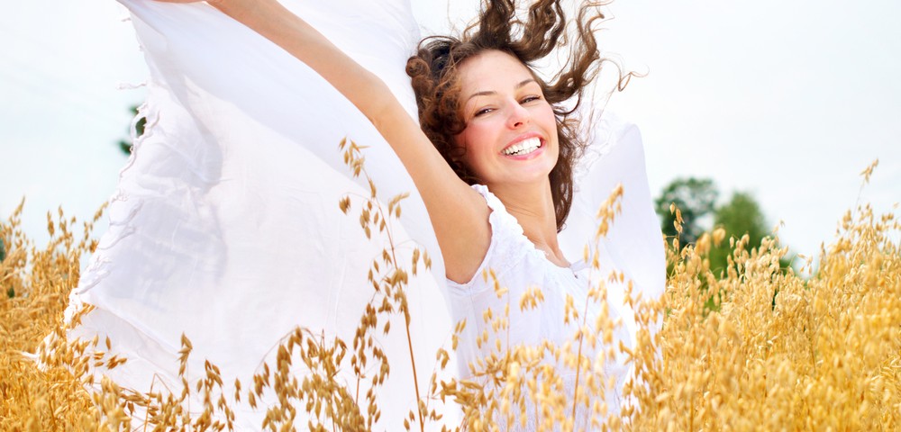 Beautiful Happy Girl on the Wheat Field