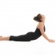 young woman demonstrating difficult yoga posture, full body side view, dressed in black, on white background