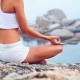 yoga beach woman doing pose at the ocean for zen health and peaceful lifestyle