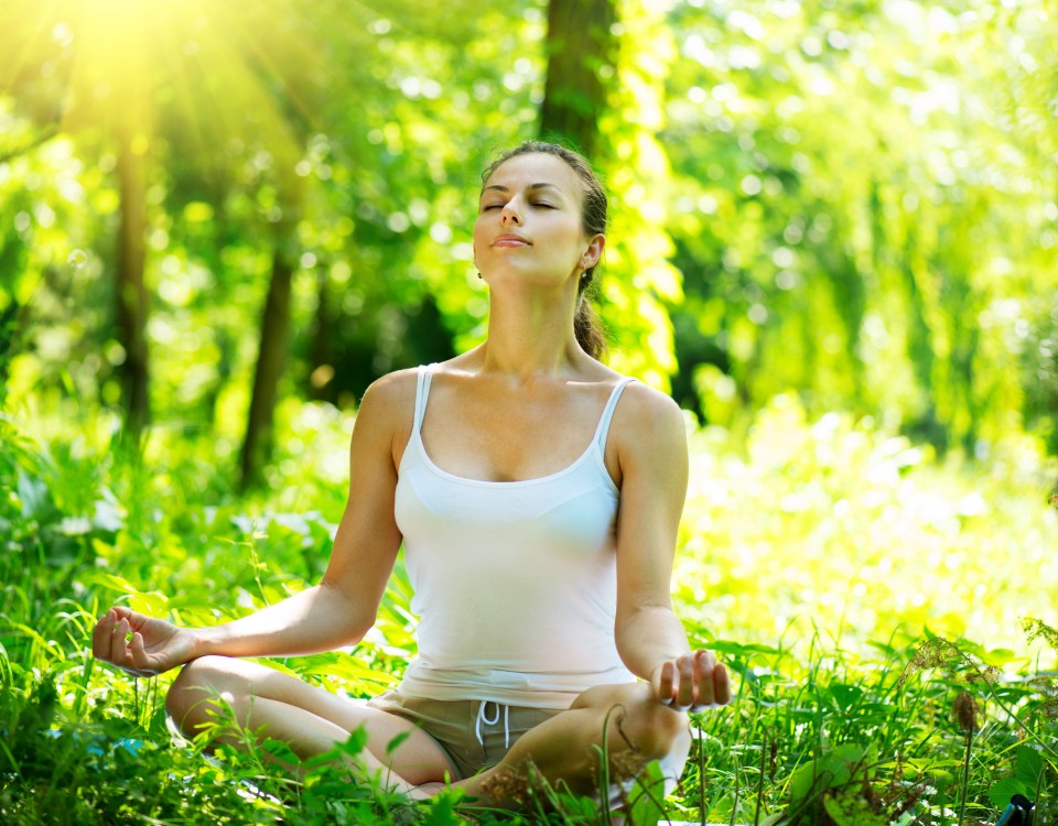 Young Woman doing Yoga Exercises Outdoor